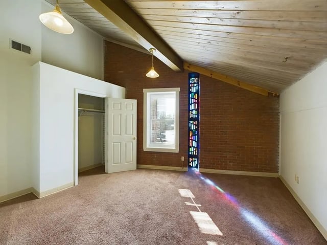 Open closet and stained glass window bedroom at Beacon Hill Apartments in Muncie Student Accommodation