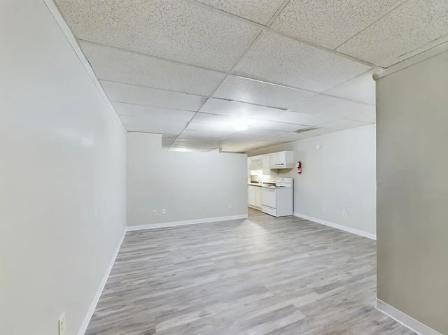 White cabinets stove and fire extinguisher kitchen living area at Beacon Hill Apartments in Muncie Student Accommodation