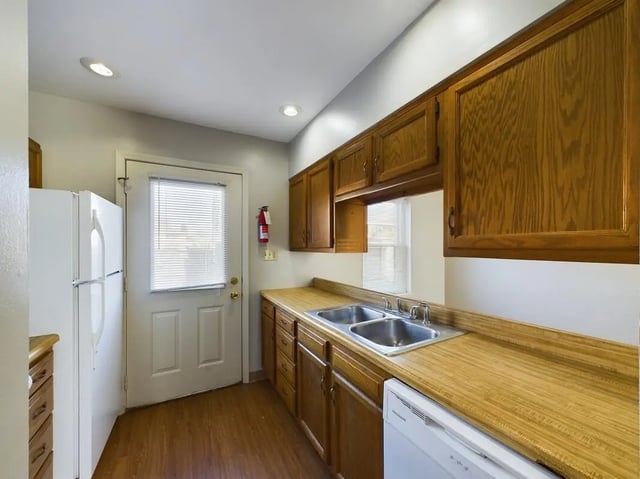 White refrigerator stainless steel sink wooden cabinets kitchen at Beacon Hill Apartments in Muncie Student Accommodation