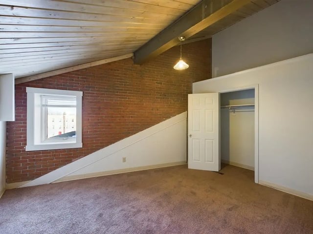 Exposed brick ceiling beam window open closet bedroom at Beacon Hill Apartments in Muncie Student Accommodation