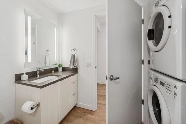 Sink mirror cabinets toilet paper washing machine bathroom at Alta Peak in Portland Student Accommodation