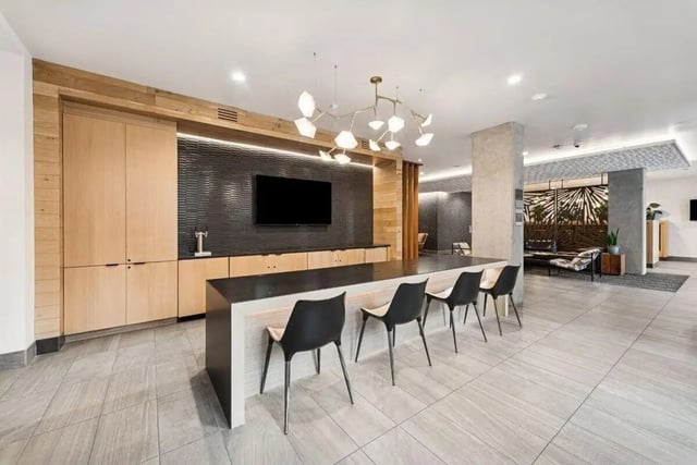 Modern communal area with counter seating and TV at Alta Peak in Portland Student Accommodation