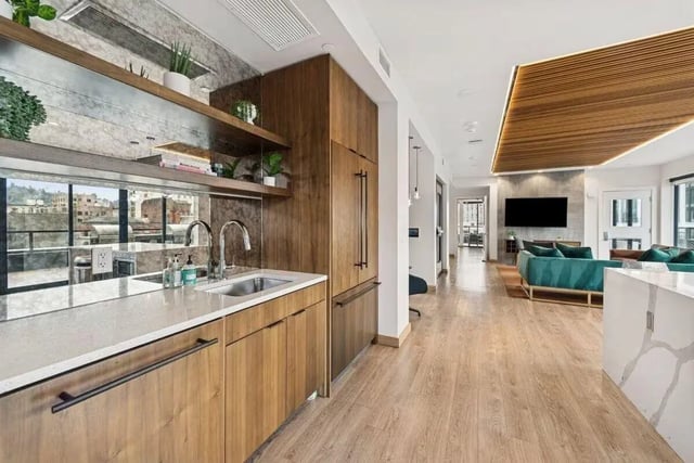 Modern kitchen with wooden cabinets sink and living area at Alta Peak in Portland Student Accommodation