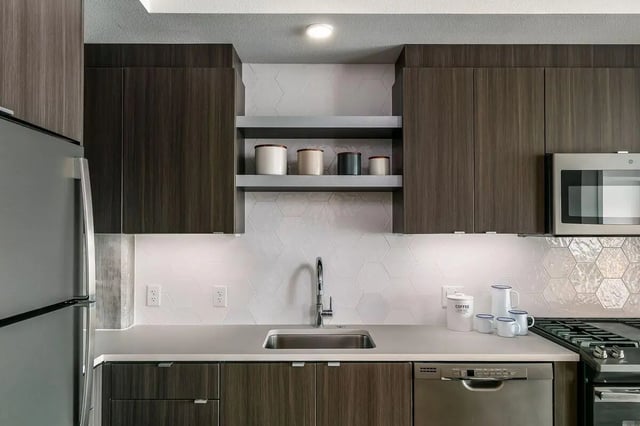 Dark wood cabinets stainless steel appliances sink kitchen at Alta Peak in Portland Student Accommodation