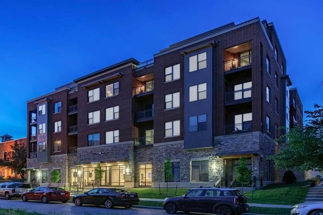 Modern apartment building with balconies and cars exterior at Breckenridge Apartments Iowa City in Iowa City Student Accommodation