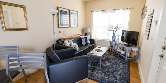 Black sofa coffee table and TV living room at Beacon Springfield in Springfield Student Accommodation