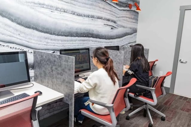 Two students at computers with desks and chairs study area at Beacon Springfield in Springfield Student Accommodation