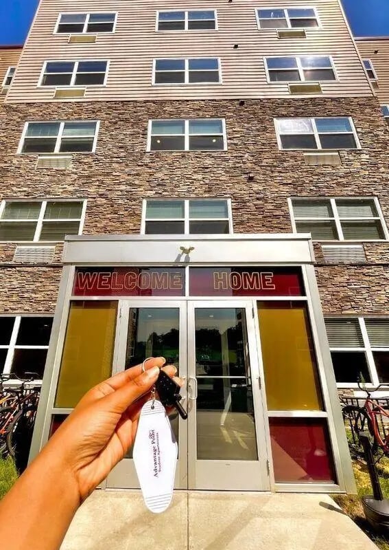 Hand holding keys welcome home sign exterior at Advantage Point Student Apartments in Kutztown Student Accommodation
