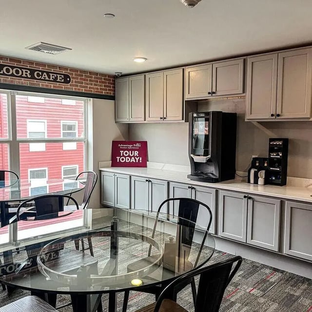 Coffee maker tables chairs cabinetry cafe area at Advantage Point Student Apartments in Kutztown Student Accommodation