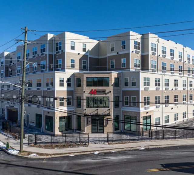 Modern beige and brown apartment building exterior at 44 Courtlandt in New Brunswick Student Accommodation