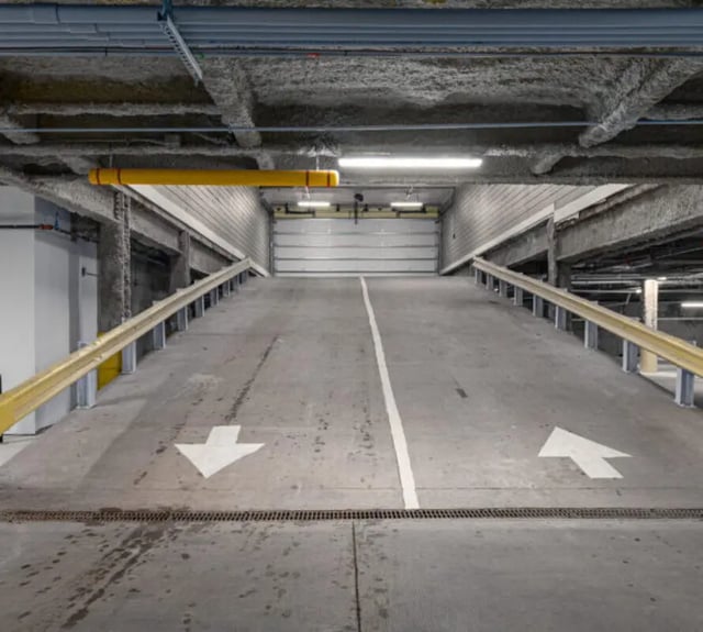 Parking garage ramp with arrows and yellow rail exterior at 44 Courtlandt in New Brunswick Student Accommodation