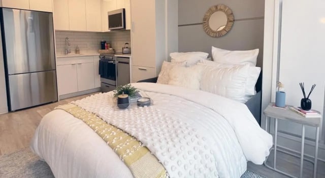 Bed with kitchen area and modern appliances bedroom at 7 INK in Boston Student Accommodation