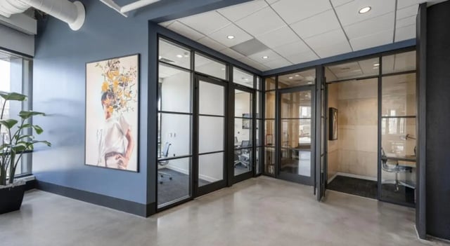 Glass partitioned offices with artwork and plant Exterior at 7 INK in Boston Student Accommodation