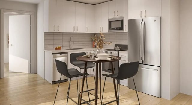 Kitchen with table chairs refrigerator and microwave kitchen at 7 INK in Boston Student Accommodation