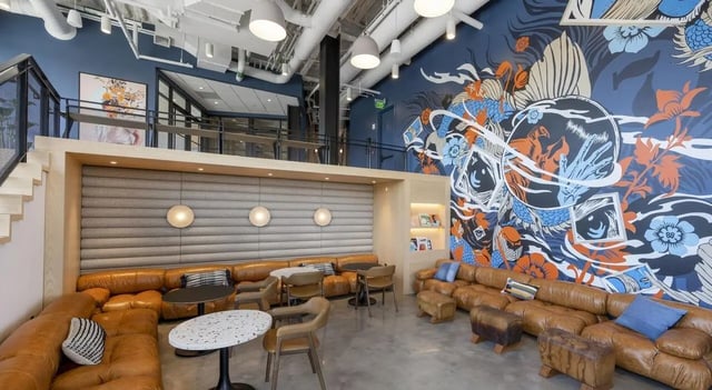 Brown leather sectional sofa mural and tables lounge at 7 INK in Boston Student Accommodation