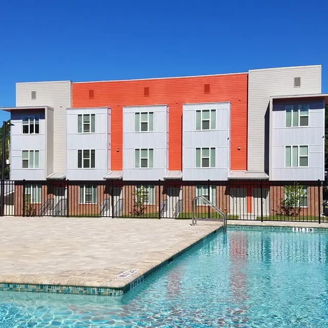 Modern student housing building with swimming pool exterior at Arive850 in Tallahassee Student Accommodation