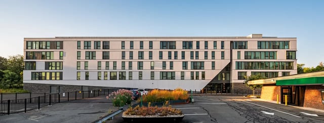 Modern white building with many windows exterior at 11 East Pleasant in Amherst Student Accommodation