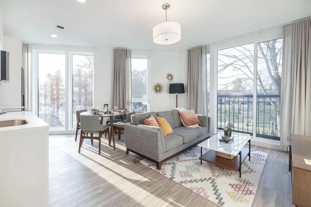 Sofa dining table patterned rug living room at 11 East Pleasant in Amherst Student Accommodation