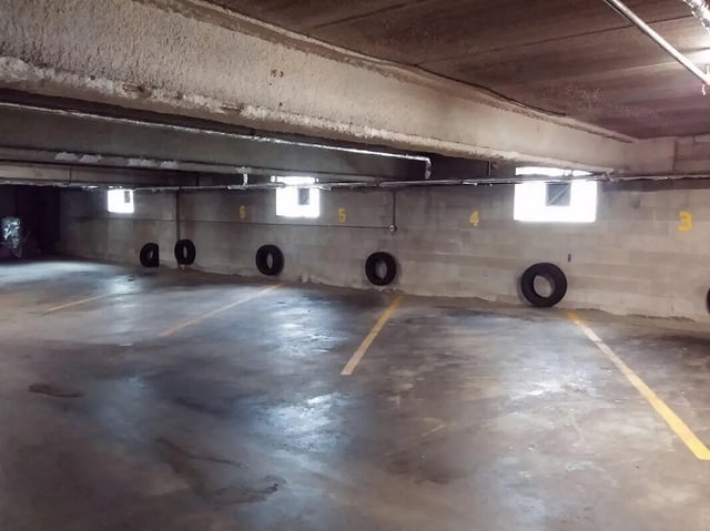 Parking spots with tires and yellow lines parking garage at Campus Court in Milwaukee Student Accommodation