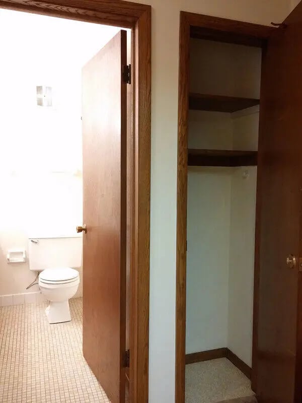 Toilet and empty shelves Bathroom closet at Campus Court in Milwaukee Student Accommodation