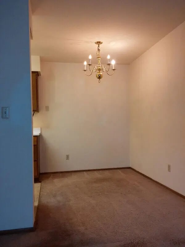 Chandelier over empty carpeted dining area at Campus Court in Milwaukee Student Accommodation
