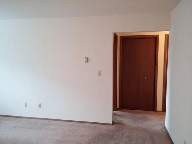 White walls carpeted floor double doors closet interior at Campus Court in Milwaukee Student Accommodation