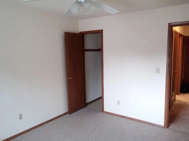 Empty room with closet and doors Bedroom at Campus Court in Milwaukee Student Accommodation