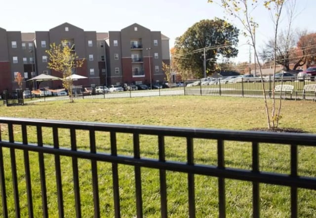 Apartment building with parking lot and benches exterior at Bear Village Apartments in Springfield Student Accommodation