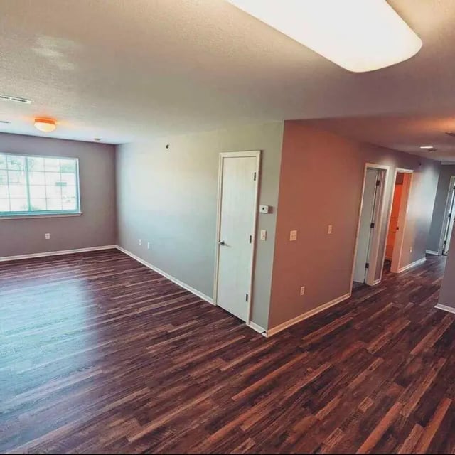 Empty room wood floor window and doors living room at Crimson Villas in Pittsburg Student Accommodation