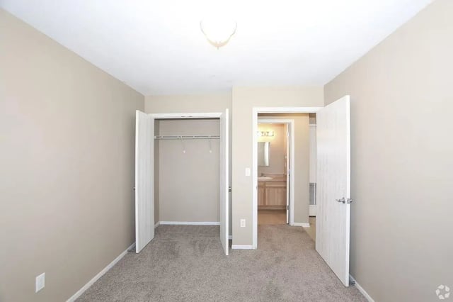 Empty closet and doorway to bathroom bedroom at Crimson Villas in Pittsburg Student Accommodation