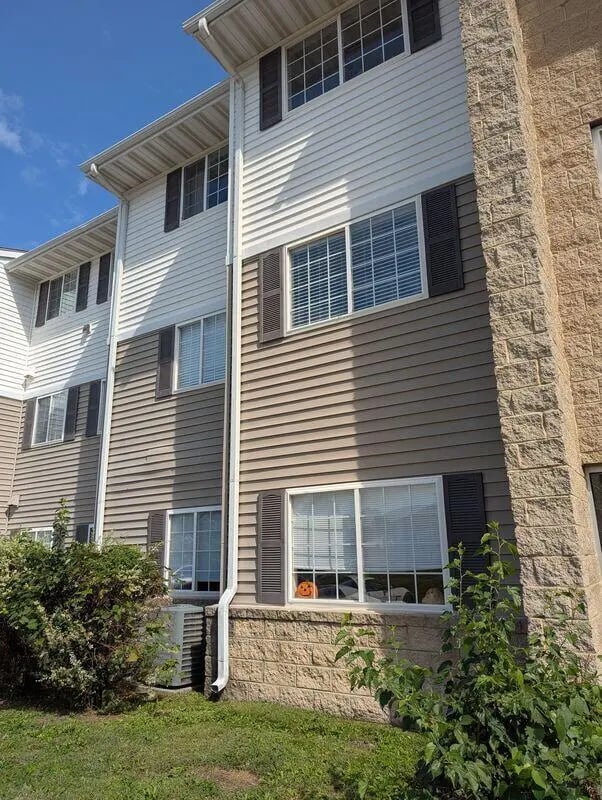 Building exterior with windows and outdoor unit Exterior at Crimson Villas in Pittsburg Student Accommodation
