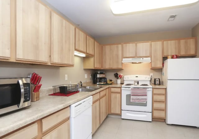 Microwave dishwasher stove refrigerator and cabinets kitchen at Crimson Villas in Pittsburg Student Accommodation