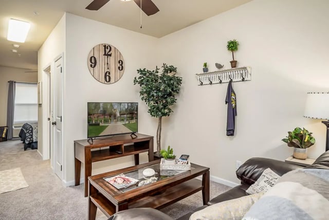 Living room with TV clock and sofa living room at Eagle Summit Apartments in Cookeville Student Accommodation