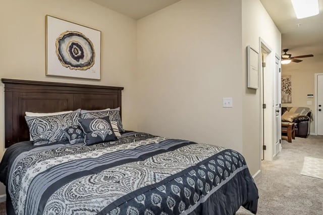 Bed with patterned duvet and pillows bedroom at Eagle Summit Apartments in Cookeville Student Accommodation