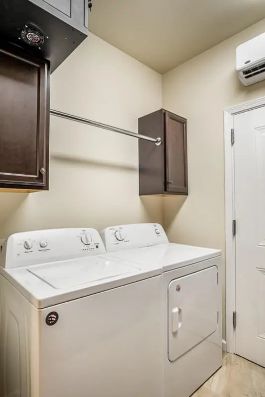 Washer dryer and cabinets laundry room at Eagle Summit Apartments in Cookeville Student Accommodation