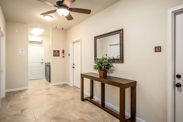 Hallway with mirror table plant doors kitchen Interior at Eagle Summit Apartments in Cookeville Student Accommodation