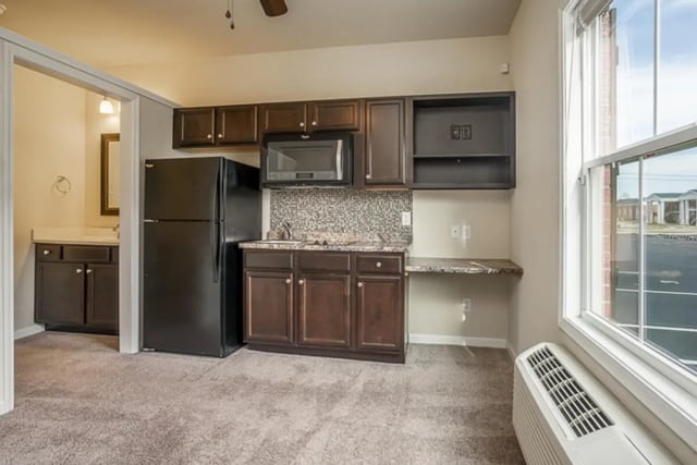Fridge microwave cabinets sink kitchen area at Eagle Summit Apartments in Cookeville Student Accommodation