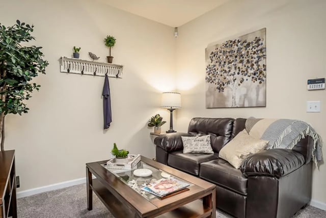Leather couch coffee table and artwork living room at Eagle Summit Apartments in Cookeville Student Accommodation