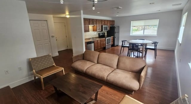 Sofa coffee table chairs kitchen and living room living room at Clyde Street Apartments in Pittsburgh Student Accommodation