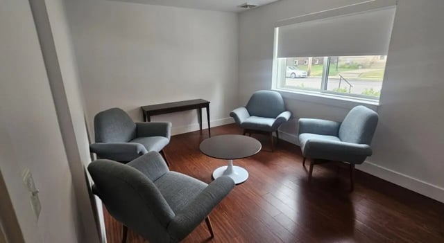 Four chairs round table console table living room at Clyde Street Apartments in Pittsburgh Student Accommodation