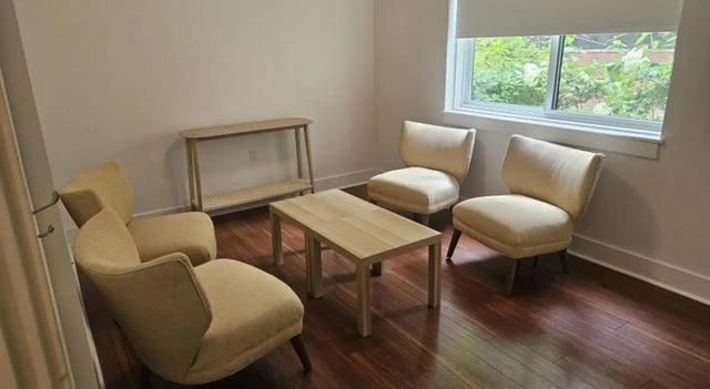 Four chairs and table in a living room at Clyde Street Apartments in Pittsburgh Student Accommodation