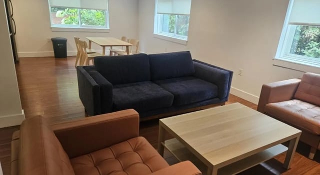 Two sofas coffee table dining set living room at Clyde Street Apartments in Pittsburgh Student Accommodation