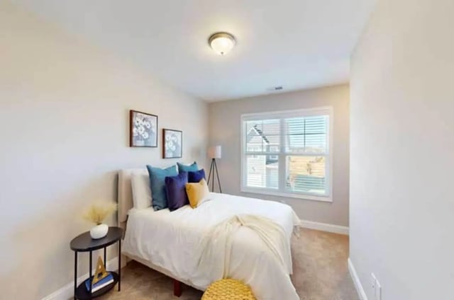 Bed with pillows and framed art bedroom at 11 at Main in Winterville Student Accommodation