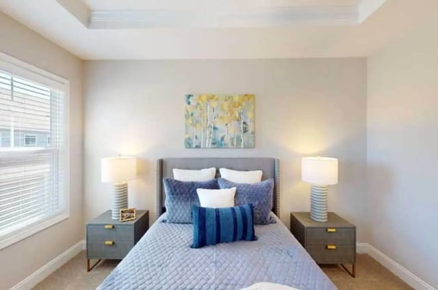Quilted bed blue pillows nightstands lamps painting bedroom at 11 at Main in Winterville Student Accommodation