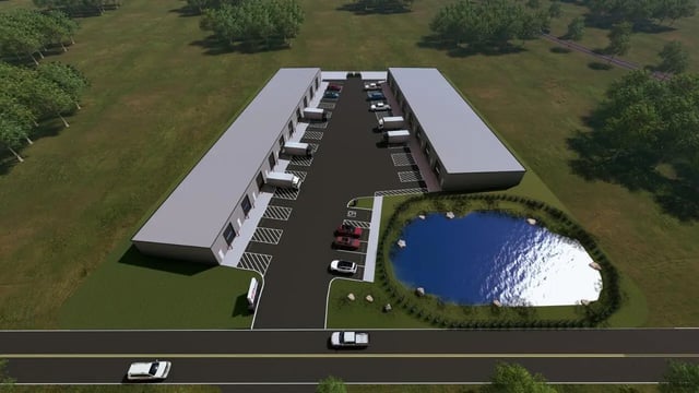 Buildings trucks pond and cars exterior at 11 at Main in Winterville Student Accommodation
