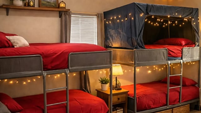 Bunk beds with red bedding and string lights bedroom at Affordable SoCal Living in Los Angeles Student Accommodation