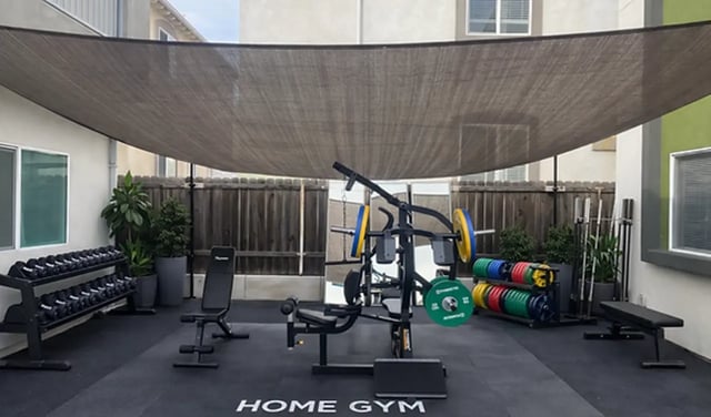 Dumbbells weight rack weight bench gym equipment exterior at Affordable SoCal Living in Los Angeles Student Accommodation