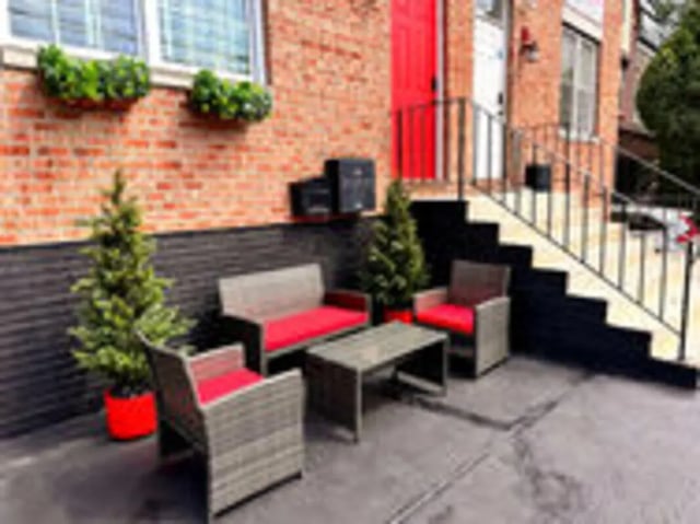 Wicker seating and coffee table exterior at Art Sharm Living in Philadelphia Student Accommodation