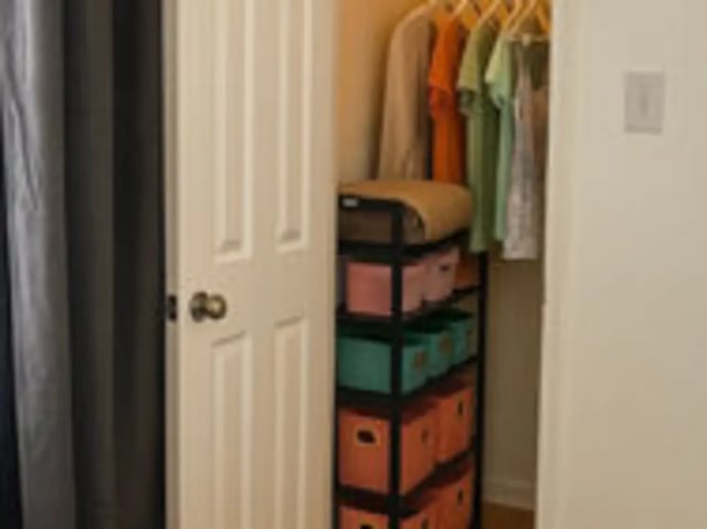 Open closet with clothing and storage bins bedroom at Art Sharm Living in Philadelphia Student Accommodation