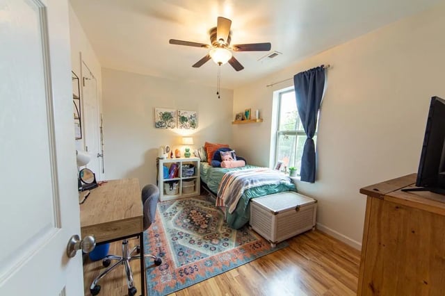 Desk bed shelving rug and chest bedroom at 494 Lofts in Boone Student Accommodation